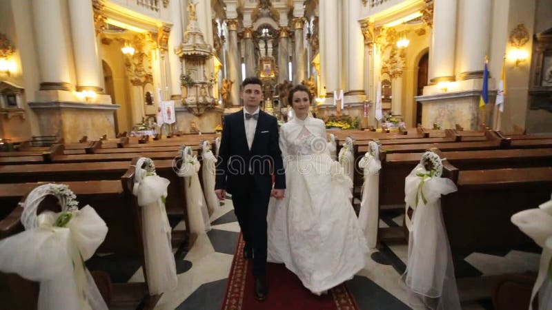 Bride and groom go out of the church