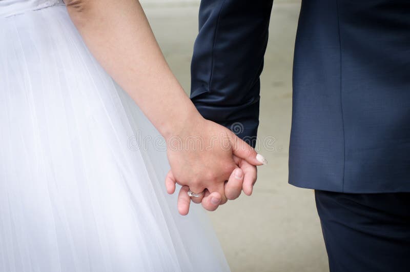 Bride and groom holding hands