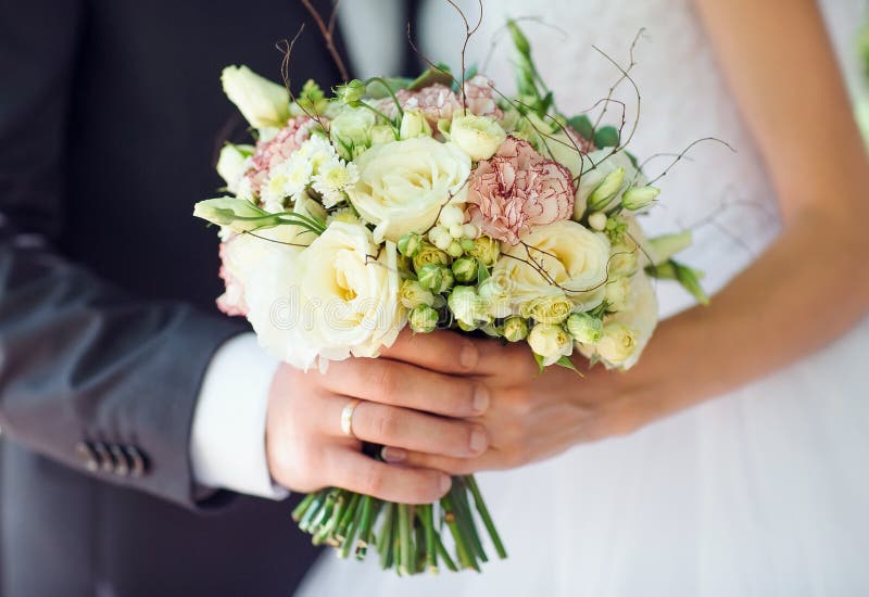 Bride and Groom Holding Wedding Bouquet Hand in Hand. Stock Photo ...