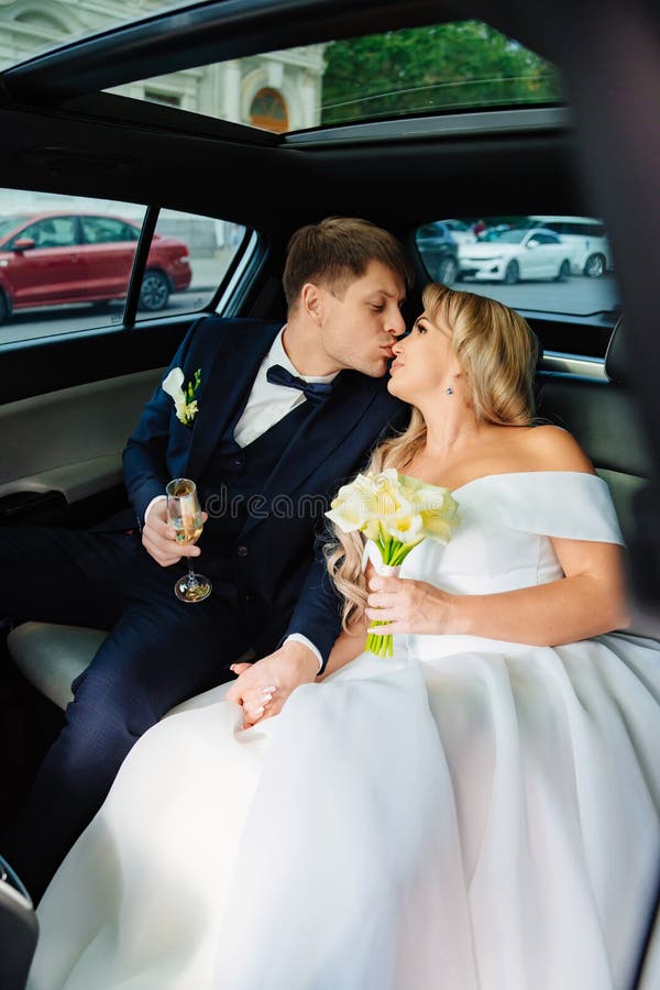 The Bride And Groom Kiss In The Back Seat Of The Car Happy Newlyweds Stock Image Image Of