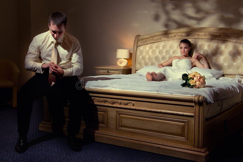 Bride and groom lying on bed