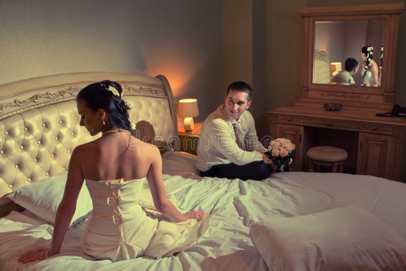 Bride and groom lying on bed