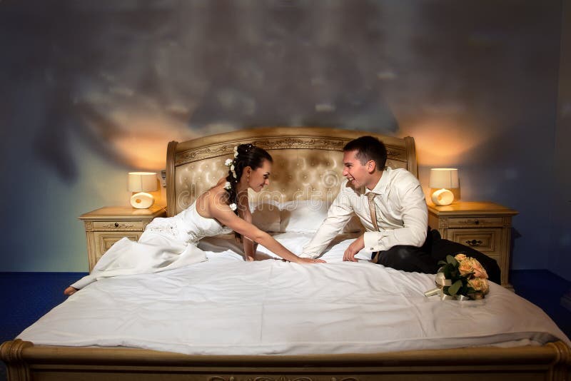 Bride and groom lying on bed