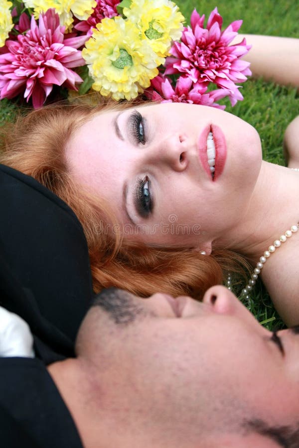 Bride and Groom lying on grass