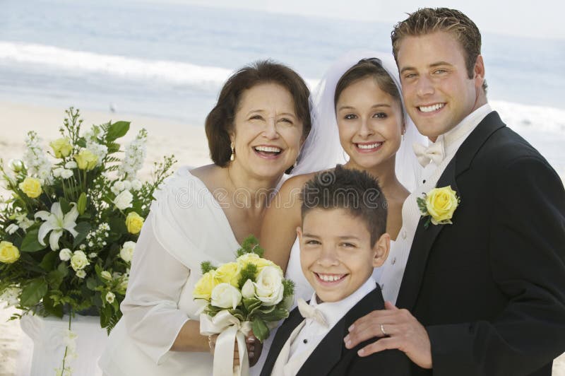 Bride and Groom with mother and brother outdoors (portrait)