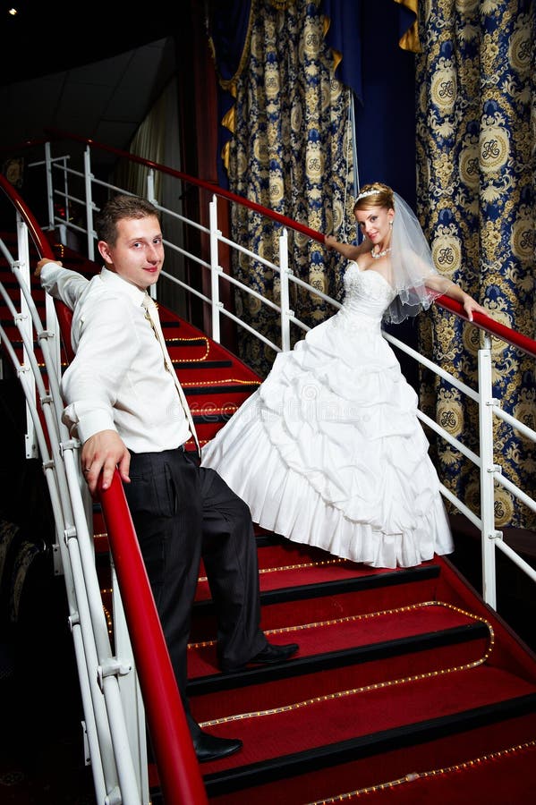 Bride and groom on the red stairs