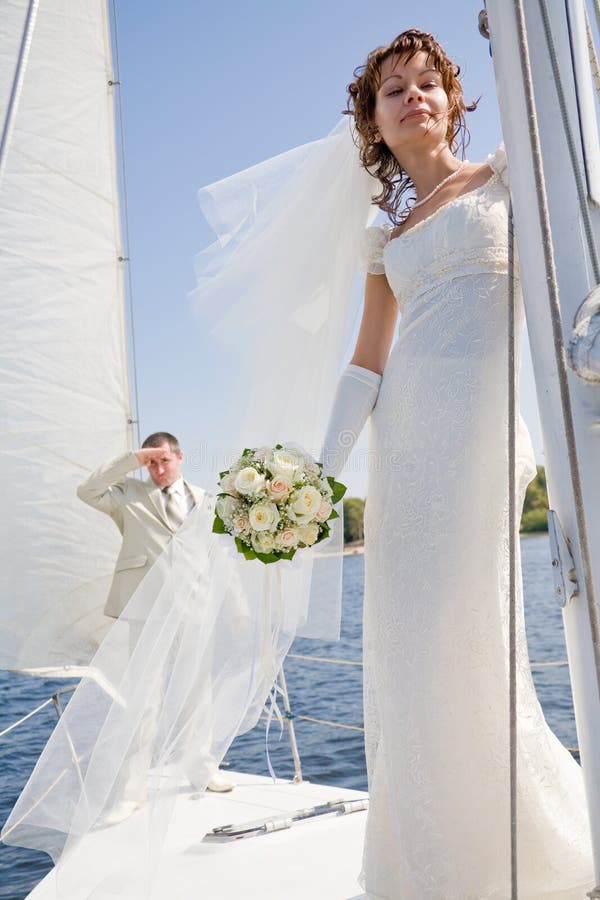 Bride and groom sailing on white yacht