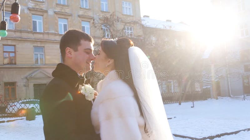 The bride and groom are on a snowy road