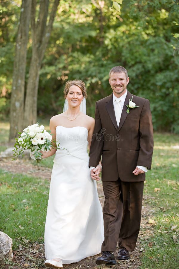 Bride and Groom Walking Along a Path stock images Bride and Groom Walking Along a Path stock images