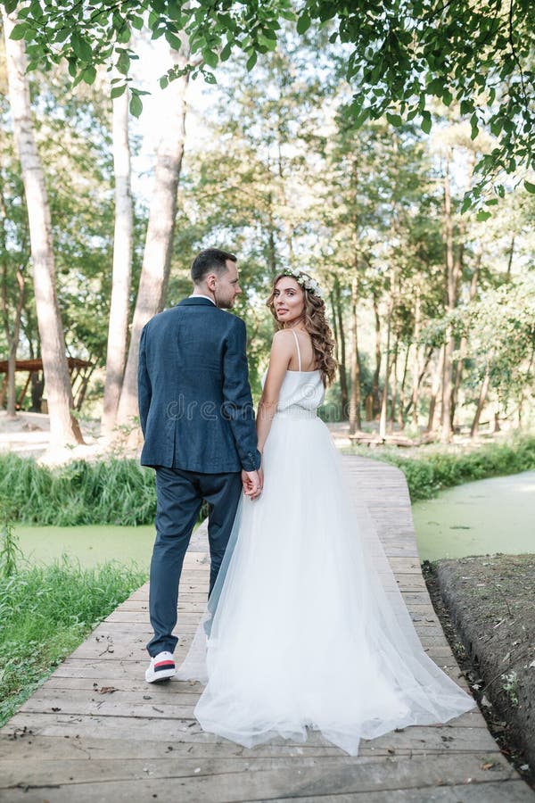 Bride and groom at wedding Day walking Outdoors on summer nature. Bridal couple, Happy Newlywed royalty free stock photo Bride and groom at wedding Day walking Outdoors on summer nature. Bridal couple, Happy Newlywed royalty free stock photo