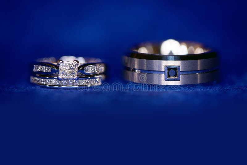 Pair Of Modern Gold Wedding Rings On White And Blue Background High-Res  Stock Photo - Getty Images