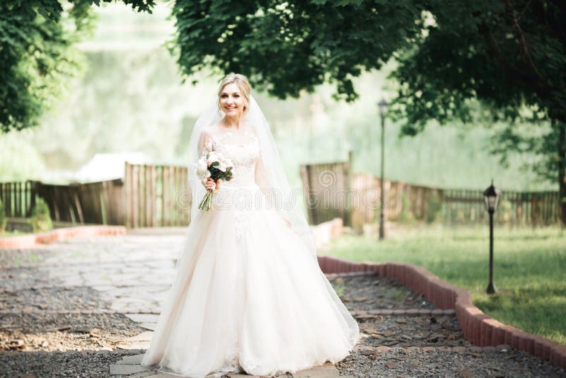 Bride Holding Big and Beautiful Wedding Bouquet with Flowers Stock