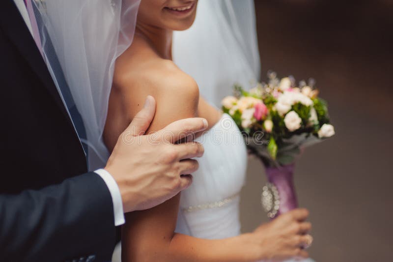 Bride holding big wedding bouquet on wedding ceremony. Bloom, color.