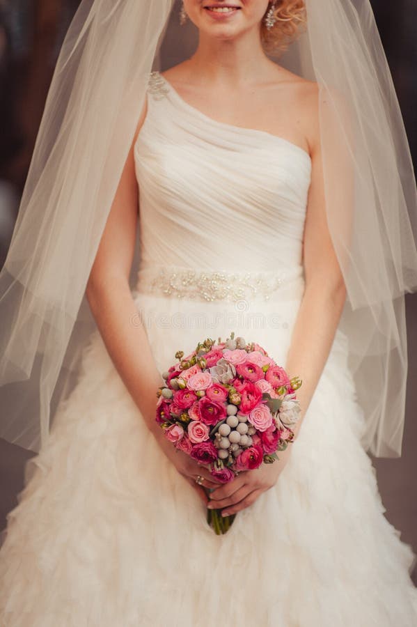 Bride holding big wedding bouquet on wedding ceremony. Flower, beautiful.