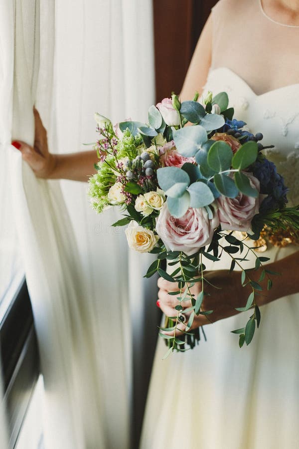 Bride Holding Her Bouquet in Her Lap during Her Wedding Stock Image