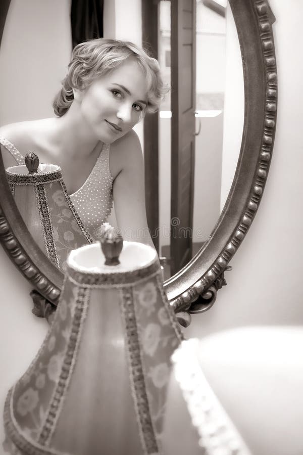 Bride looking in a mirror stock