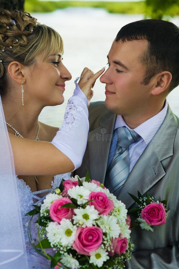 The bride looks after the groom