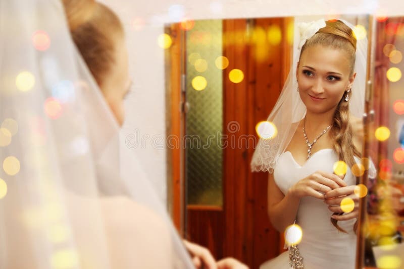 Bride looks in the mirror