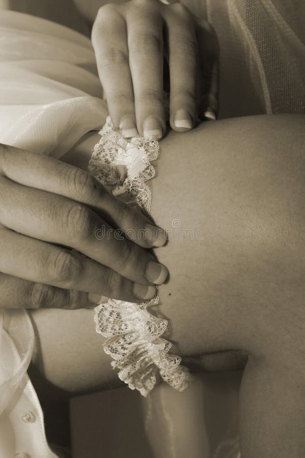 Bride putting on her garter