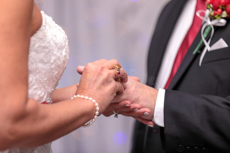 Bride Putting A Wedding Ring On Groom S Finger. Wedding Ceremony Stock