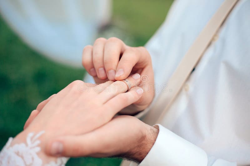 Bride Putting a Wedding Ring on Finger Stock Photo Image of spouse