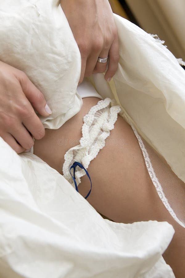 Bride showing her leg with garter