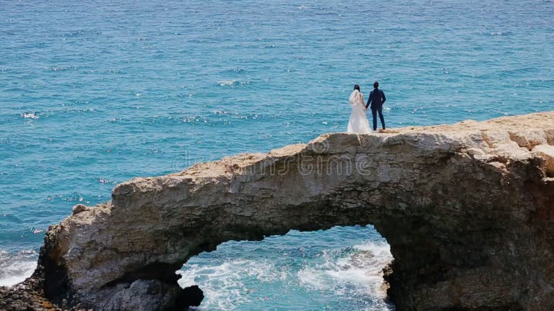 Bride on a stone bridge in the sea