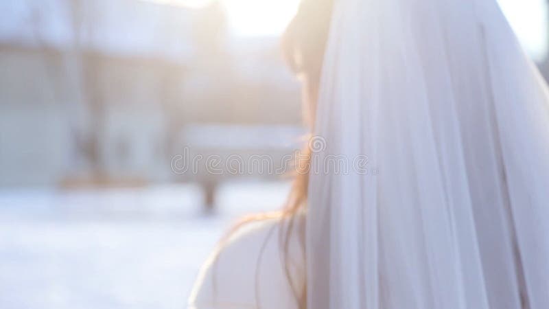 Bride in stylish serenity dress walk away and turn her head