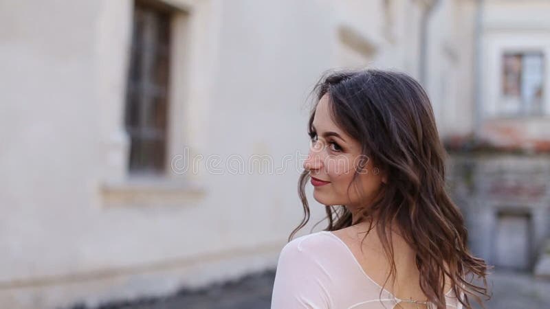 Bride in stylish serenity dress walk away and turn her head