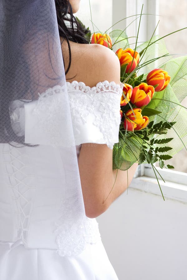 Back of beautiful bride with bunch of tulips. Back of beautiful bride with bunch of tulips