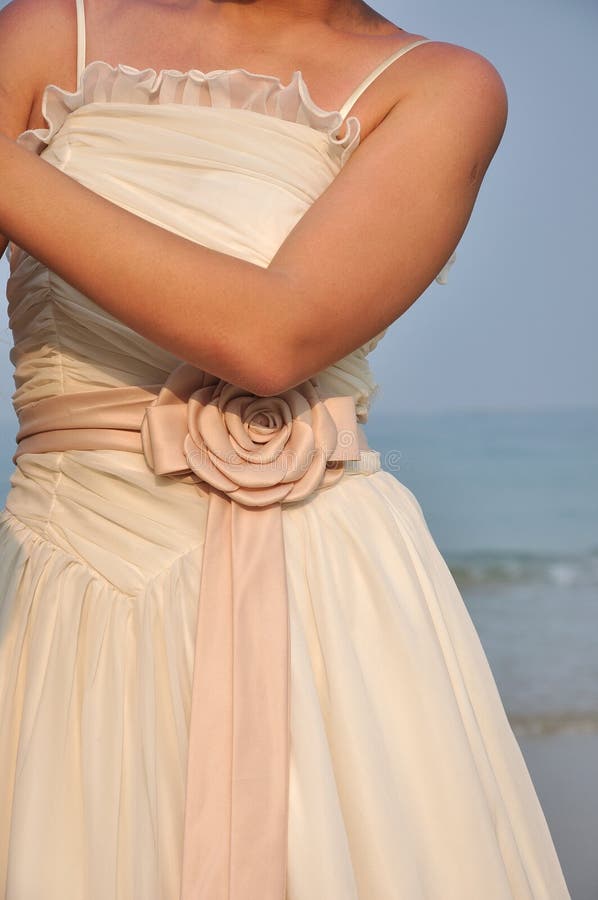Bride in wedding dress under sunset in the beach stock images Bride in wedding dress under sunset in the beach stock images