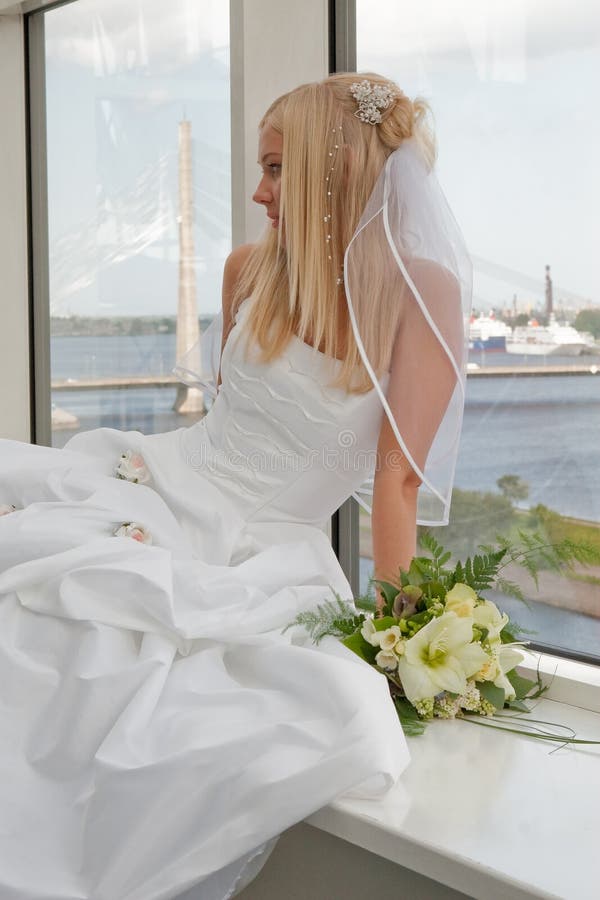 Bride on the window stock images
