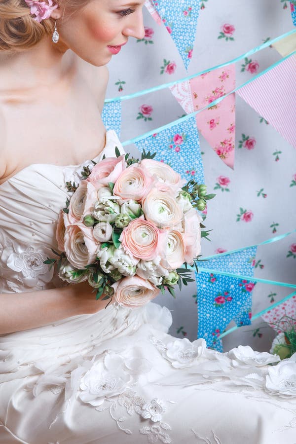 Bride.Young fashion model with make up, ,curly hair, flowers in hair. Bride fashion. Jewelry and Beauty.