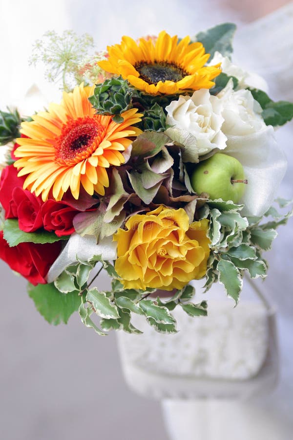 A close up portrait of a bride's bouquet of flowers. They are seen here in a beautiful bunch, being held in her hand. A bride is the female participant in a wedding ceremony. The term bride comes from the Teutonic word for a cook. She is typically attended by one or more bridesmaids or maids of honor. Her male partner is the bridegroom or groom. Before a bride can be formally called wife. A close up portrait of a bride's bouquet of flowers. They are seen here in a beautiful bunch, being held in her hand. A bride is the female participant in a wedding ceremony. The term bride comes from the Teutonic word for a cook. She is typically attended by one or more bridesmaids or maids of honor. Her male partner is the bridegroom or groom. Before a bride can be formally called wife