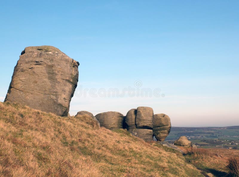 The bridestones a large group of gritstone rock formations in west yorkshire landscape near todmorden against pennine countryside