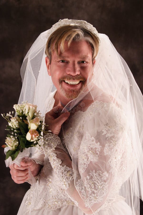 A stock image of a masculine man dressed in a bridal gown. Comical. A stock image of a masculine man dressed in a bridal gown. Comical.