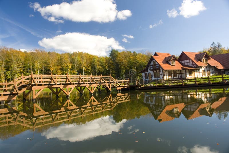 Bridge and chalet in woods royalty free stock images