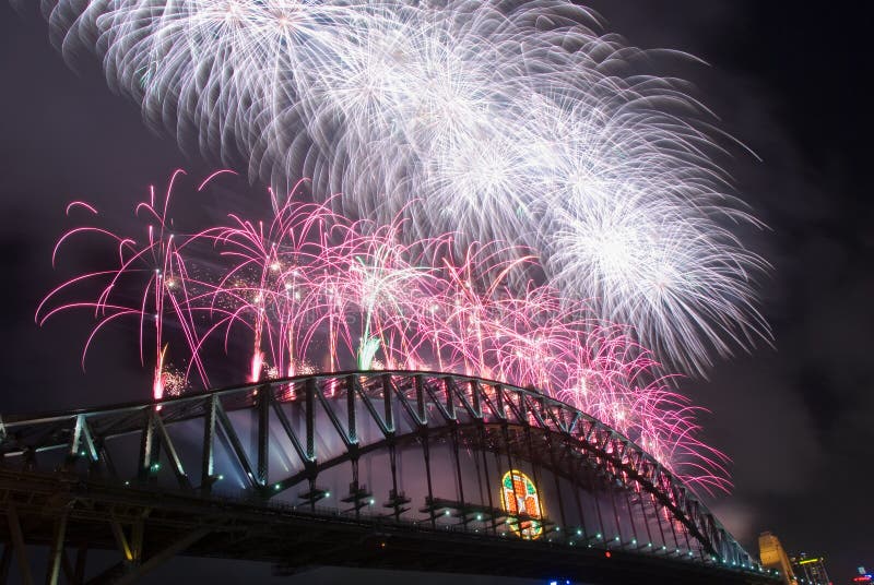 Sparkling New Year Eve nye Fireworks in Sydney Harbour Sky Line At Night, NSW, Australia, Oceania. The Sydney harbour bridge and sydney opera house sparkling in the night. Colourful surface. Night scene, panorama. Sparkling New Year Eve nye Fireworks in Sydney Harbour Sky Line At Night, NSW, Australia, Oceania. The Sydney harbour bridge and sydney opera house sparkling in the night. Colourful surface. Night scene, panorama