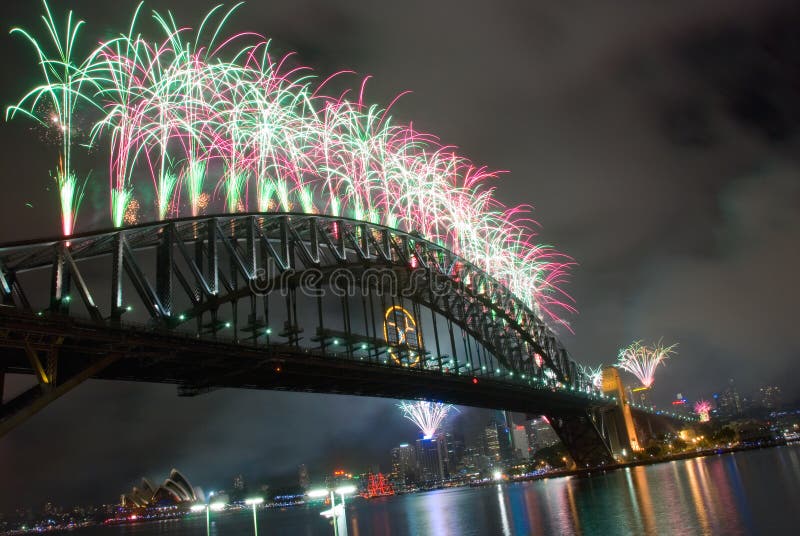 Sparkling New Year Eve nye Fireworks in Sydney Harbour Sky Line At Night, NSW, Australia, Oceania. The Sydney harbour bridge and sydney opera house sparkling in the night. Colourful surface. Night scene, panorama. green red gold yellow fireworks. Sparkling New Year Eve nye Fireworks in Sydney Harbour Sky Line At Night, NSW, Australia, Oceania. The Sydney harbour bridge and sydney opera house sparkling in the night. Colourful surface. Night scene, panorama. green red gold yellow fireworks.