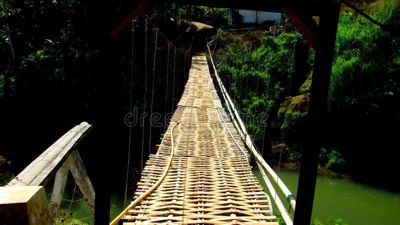 A bridge located in Kampung Kosambi, Subdistric Karangjaya, Tasikmalaya Regency West Java, usually this bridge is used by residents` activities in transporting their garden produce. A bridge located in Kampung Kosambi, Subdistric Karangjaya, Tasikmalaya Regency West Java, usually this bridge is used by residents` activities in transporting their garden produce