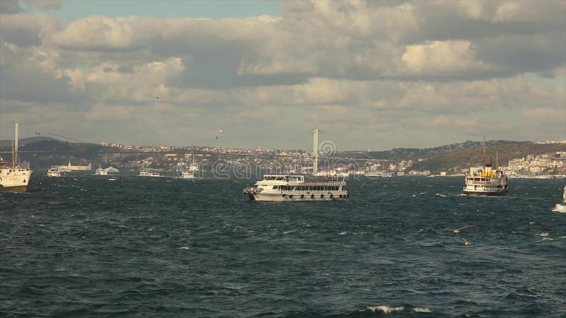 Bridge over the Bosphorus, beautiful clouds and pleasure boats. Bosphorus bridge over the river stock video