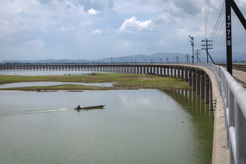 Bridge Over the River,railroad Tracks and Boat Sailing on Water Stock