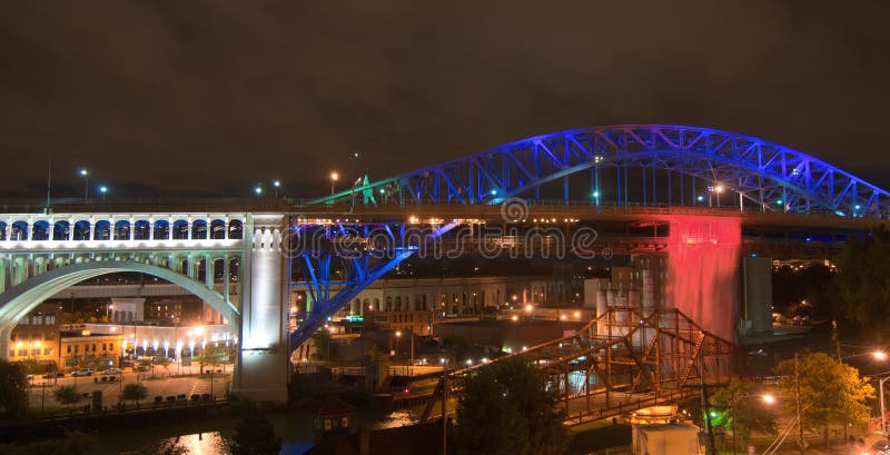 An illuminated man-made waterfall pours from the deck of bridge in Cleveland Ohio. Man made waterfall stock images, royalty-free photos and pictures