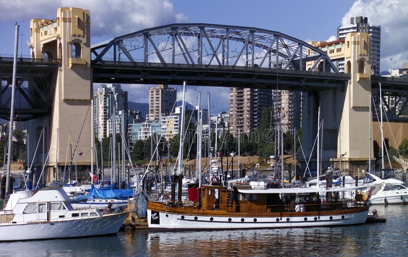 Burrard Bridge in the city of Vancouver in British Columbia in western Canada. It carries a five-lane highway over False Creek and the busy marinas of Granville Island. Burrard Bridge in the city of Vancouver in British Columbia in western Canada. It carries a five-lane highway over False Creek and the busy marinas of Granville Island.