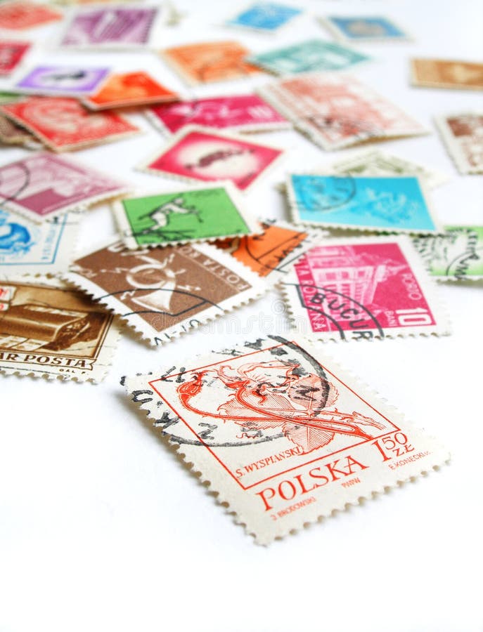 A still life image showing many postage stamps from all around the world, randomly scattered and in bright colors. A still life image showing many postage stamps from all around the world, randomly scattered and in bright colors.