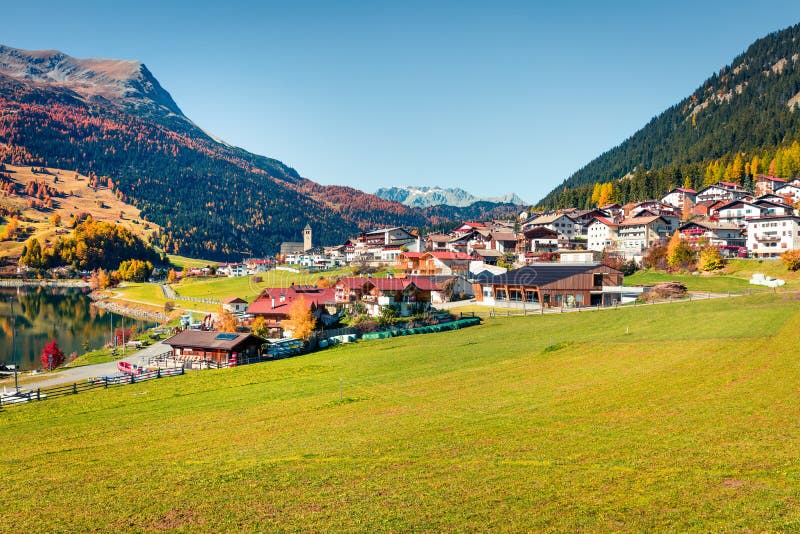 Bright autumn view of Resia village. Amazing morning scene of Italian Alps, South Tyrol, Italy, Europe. Traveling concept