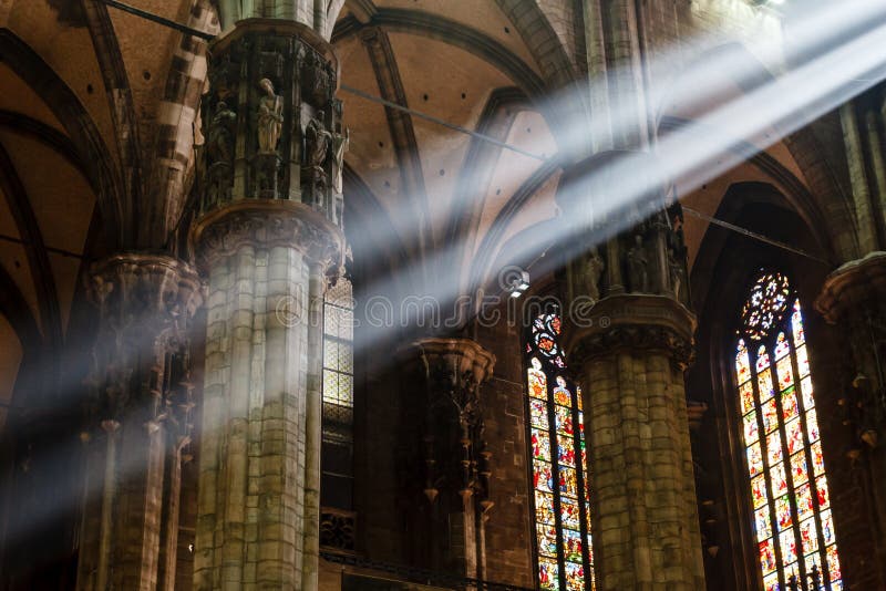 The Bright Beam of Light Inside Milan Cathedral stock photo