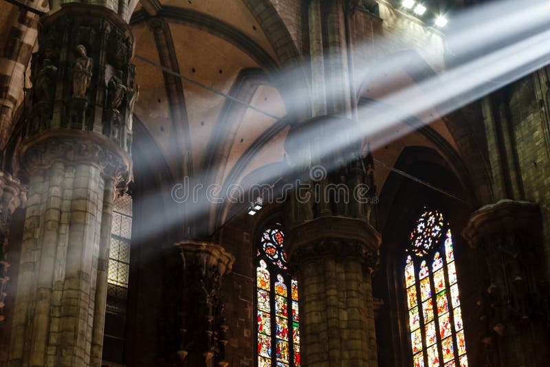 The Bright Beam of Light Inside Milan Cathedral stock photography