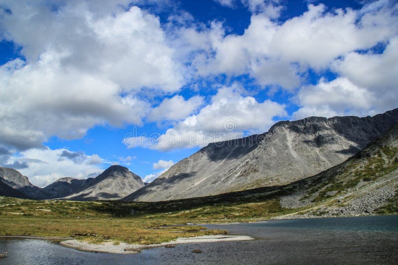 Bright blue sky with clouds over the mountain and lake royalty free stock photos Bright blue sky with clouds over the mountain and lake royalty free stock photos