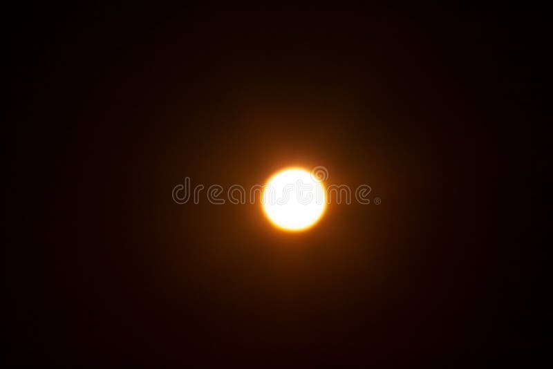 Bright Blurred Yellow Spot. the Sun on a Black Background Stock Image